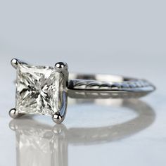 an engagement ring with a princess cut diamond