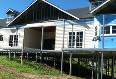 the house is being built and ready to be moved into its new home on stilts