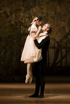 a man and woman dance together in the dark