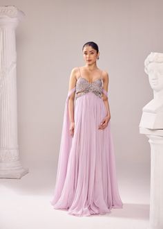 The Clara gown is a true amalgamation of fine couture craftsmanship as the bodice is meticolously embroidered with detailed aari work. The 'infinity flair' of the gown is the key element. The linning has shorts which adds a little more drama to the entire look. Colour: Lilac Material: Italian- Gown No of components: 1 Surface Ornamentation: Hand Embroidery Care Instructions: Dry Clean Shipping Time: 3-4 weeks Surface Ornamentation, Shirt Jacket Men, Drape Saree, Aari Work, Silk Roses, Co Ord Set, Dress Suits, Western Shirts, Anarkali