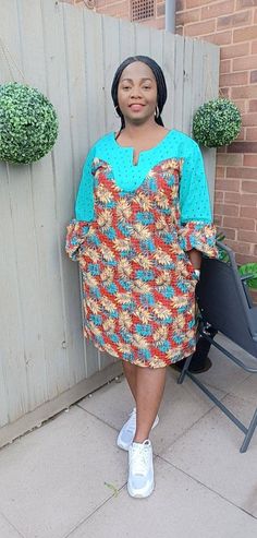 Ankara midi shift dress with beautifully intricate lace detailing is gorgeous and on trend with fitted to puff sleeve. Perfect for informal events, get to together when you simply need to make an effortless statement!  Unlined Colour: multi - colour Fit: loosely shaped Sleeve: fitted regular Pocket: two side pockets Length: knee African print  CARE INSTRUCTIONS: Hand wash cold. DO NOT BLEACH. Hang dry. Press with cool iron on the wrong side only. Colour may vary slightly due to lighting. Ankara With Lace, Ankara Print Dress, Dress African, Ankara Print, Midi Shift Dress, African Print Dress, African Clothing, Dress Clothes For Women, African Print