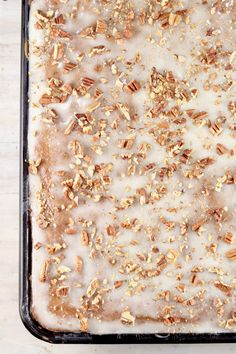 a pan filled with oatmeal and nuts on top of a table