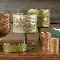 several different colored cups and bowls on a table