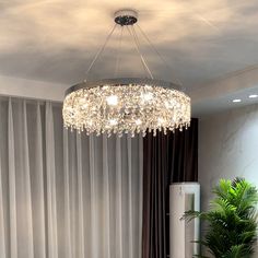 a chandelier hanging from the ceiling in a living room