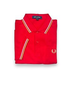 a red polo shirt with white and yellow stripes on the collar, in front of a white background