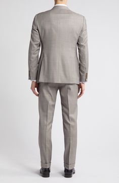 Dapper and distinctive, this pale-brown wool suit features traditional detailing and makes a smart choice for warm-weather occasions. Jacket has notched lapels; four-button cuffs; chest pocket; flap pockets; side vents Trousers have zip fly with button-tab closure; slant pockets; back button-welt pockets Jacket is lined; trousers are lined to the knee 100% virgin wool Dry clean Imported