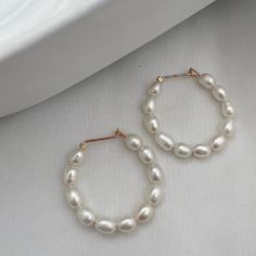 We think every woman should own some pearls. There's nothing like the beauty and luster of a pearl. They're a staple in every jewelry box. That being said we love our pearls to be different, unique, and unexpected. Stun in our Baby Pearl Hoop Earrings. Handmade ear wires in sterling silver or 14kt gold fill with genuine freshwater rice pearls. 1 inch diameter hoop. Pearl Teardrop Hoop Earrings As Gift, Pearl Teardrop Hoop Earrings For Gift, Teardrop Pearl Hoop Earrings For Gifts, Everyday Pearl Hoop Earrings With Pearl Pendant, Everyday Hoop Earrings With Pearl Pendant, Pearl White Hoop Earrings With Pearl Drop, Dainty Pearl Chain Hoop Earrings As Gift, Anniversary Hoop Earrings With Pearl Drop, Gift Pearl White Hoop Earrings With Pearl Chain