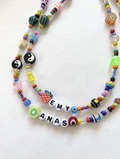 Personalized Name Word Necklace You will receive 1 necklace with a personalization (name/word) and length of your choice. Beaded by me with luuvvvv and will look similar to those pictured <3Strung on strong cord with a mixture of glass, clay and plastic beads. Some beads you might see on your necklace — evil eye, butterfly, heart, rainbow, fruit, smiley face, any many more! Beads are random and fun!! Lobster clasp closure. Can also put little seed beads in between the letters/words as seen in Personalized Round Beads Jewelry For Festival, Personalized Festival Jewelry With Round Beads, Trendy Personalized Round Bead Necklace, Trendy Personalized Round Beads, Personalized Multicolor Bohemian Necklace, Trendy Personalized Multicolor Beaded Necklaces, Fun Personalized Beaded Necklaces With Round Beads, Fun Letter Beads Necklace For Jewelry Making, Fun Personalized Beaded Necklaces