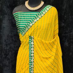 Product Detail - yellow colored casual wear saree is made from moss georgette fabric which is highlighted with beautiful stripes printed work with lace border as shown. Comes along unstitched heavy gota blouse piece which you can customise as per your design/style. Occasion - You can wear this saree for casual, outings, social meets and other homely events. Style it up - Look glamorous in this traditional saree by (HELUM FAB) Pair this saree with beautiful clutch to complete the look!! Measureme Yellow Georgette Pre-draped Saree With Pallu, Yellow Cutdana Blouse Piece For Navratri, Yellow Unstitched Blouse Piece With Traditional Drape, Green Georgette Dupatta With Printed Border, Yellow Bollywood Style Pre-draped Saree In Georgette, Yellow Bollywood Pre-draped Georgette Saree, Unstitched Yellow Saree With Cutdana, Unstitched Yellow Cutdana Saree, Yellow Cutdana Unstitched Saree