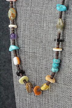 This turquoise, coral, lapis, amber, spiny oyster, mother of pearl, abalone, jasper, onyx, amethyst and sterling silver necklace was made by Navajo artisan Helen Tsosie.Necklace: 28" with an additional 2" extender chainWidth: 1/8" to 3/8"Free shipping on all orders! We ship with USPS and always include tracking. All orders ship within a day of payment.Returns are accepted up to 30 days after you receive your order. Just send us a message. Our shop offers cash back or store credit. The item must be returned in new condition. One Of A Kind Multicolor Healing Necklaces, Multicolor Hand-strung Agate Jewelry, Earthy Multicolor Beaded Necklaces With Natural Stones, Southwestern Adjustable Multi-stone Jewelry, Brown Turquoise Necklace With Natural Stones, Spiritual Style, Earthy Multicolor Gemstone Jewelry, Handmade Adjustable Multicolor Gemstones, One Of A Kind Multicolor Amulet Beaded Necklaces, Multicolor Amulet Jewelry With Gemstone Beads