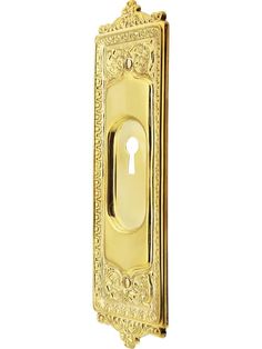 a golden door handle with an ornate design on the front and side panel, which has a keyhole in the middle