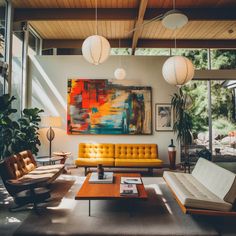 a living room filled with lots of furniture and large paintings on the wall above it