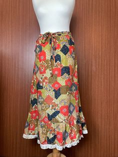 A lovely 1950s Floral Skirt. Tie belt around the waist, and clasp fastening on either side Waist 30 inches Length 32 inches Great condition Retro Spring Skirt With Belt Loops, Vintage Flared Lined Skirt, Vintage Long Lined Skirt, Vintage Cotton Maxi Skirt With Lining, Vintage Multicolor Skirt, Vintage Cotton Maxi Skirt, Vintage Multicolor Long Skirt, Vintage Cotton Tiered Maxi Skirt, Vintage Multicolor Lined Skirt