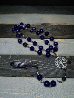 This is a beautiful re-imagined rosary based on the classic Catholic rosary.  The  beads are amethyst.  There are three decades of nine beads each.  The center is a tree of life, and I have capped it off with a amethyst pendent which can double as a spirit guide pendulum.  With this rosary I'm including a simple chant which has resonated with me, but feel free to use your own!   Pagan/witch prayer chant: Knot one, the work's begun. Knot two, my aim is true. Knot three, it will be. Knot four, pow Spiritual Rosary Bracelet With Natural Stones For Meditation, Spiritual Wire Wrapped Crucifix Jewelry, Spiritual Gemstone Beads Rosary, Bohemian Rosary With Natural Stones For Gifts, 8mm Bead Crucifix Rosary For Meditation, Crucifix Rosary With 8mm Beads For Meditation, Spiritual Rosary Bracelet With Round Beads For Healing, Spiritual Crucifix Jewelry With 8mm Beads, Spiritual Rosary Bracelet With Natural Stones For Healing