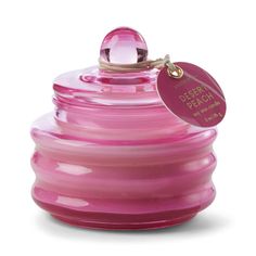 a pink glass jar with a tag on it