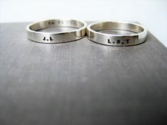 Celebrate your love, friendship, family connections with this matching set of solid sterling* personalized couple rings!  Perfect as simple, elegant, wedding rings, promise rings or anniversary rings or just because.   These minimalist rings will stack well with the other rings you wear.  Details... This set of matching, solid sterling silver couple rings includes two 3mm wide bands. The outsides of the rings can be shiny, satin or wood textured.  (You can choose the texture from the drop down menu). Ordering and customizing... When you order you can put the details for your set of couple rings in the personalization box.  The letters/numbers/symbols are individually stamped by hand (not engraved).  Please specify your size and word/date details.  For example: ring 1 - size 6 (inside) I LO Simple Elegant Wedding Rings, Wedding Ring Simple, Silver Couple Rings, Elegant Wedding Rings, Rings Promise, Simple Elegant Wedding, Heart Symbol, Personalized Couple, Tiny Heart