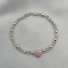 Introducing our Blush Heart and Gemstone Bead Bracelet in radiant sterling silver—a true embodiment of joy and elegance! With its delicate blush heart charm and shimmering gemstone beads, this bracelet is a celebration of love and individuality. Each bead tells a story, reflecting the wearer's unique journey and personality. Whether you're adding a pop of color to your everyday look or stacking it with other treasures, this bracelet is sure to spark joy and conversation wherever you go. Embrace Pink Silver Beaded Bracelet, Puffy Heart Charms, Spark Joy, Gemstone Beaded Bracelets, Puffy Heart, Pink Beads, Pink Bracelet, Matching Bracelets, Pink Opal