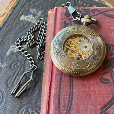 48mm mechanical pocket watch. On 30 inches of antiqued brass chain or on a mens pocket chain that hooks onto your belt. Just let me know which you’d like at checkout. Both the inside and back of the watch see through to the gear movement. The picture on the model isn’t the exact same watch but is the correct watch size for reference. The movement is mechanical and so will need wound every day its in use in order to keep accurate time. Each of my watches come in a gift box with printed care instr Pocket Chain, Mechanical Pocket Watch, Pocket Watch Antique, Gifts For Brother, Brass Chain, Mechanical Watch, Vintage Watches, Pocket Watch, Boyfriend Gifts