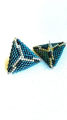 Description: Enhance your jewelry collection with these exquisite handmade snake pattern stud earrings, meticulously crafted with Miyuki Delica beads. These stunning earrings feature an intricate snake design, adding a unique and elegant touch to any outfit. Pair it with Blue Snake beaded bracelet. Details: Diameter: 24 mm Height: 0.8 inches (2 cm) Shipping details: Ships in 1 business day via USPS Standard Shipping Care instructions: To maintain the beauty of your beaded jewelry, avoid contact with water, perfumes, and lotions. Store in a dry place and handle gently to prevent damage. Beaded Triangle Earrings For Gifts, Triangle Beaded Earrings For Gifts, Colorful Beaded Round Clip-on Earrings As Gift, Colorful Beaded Round Clip-on Earrings For Gift, Unique Beaded Earrings With Bead Caps For Gift, Artisan Bead Cap Earrings, Handmade Green Triangle Earrings, Unique Handmade Triangle Earrings, Elegant Triangle Beaded Earrings Gift