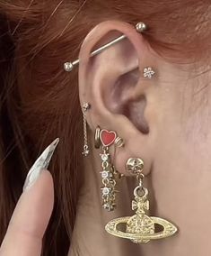 a close up of a person with ear piercings on their ears and wearing earrings