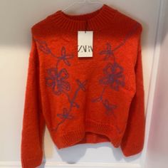 Nwt Zara Burnt Orange Sweater With Embroidered Purple Flowers. Size 13/14. Smoke Free And Pet Free Home. Orange Crew Neck Top For Winter, Trendy Embroidered Winter Tops, Trendy Embroidered Knit Sweater, Casual Embroidered Winter Sweater, Casual Embroidered Sweater For Winter, Casual Red Embroidered Sweater, Winter Embroidered Knit Tops, Embroidered Knit Tops For Winter, Zara Crew Neck Tops For Winter