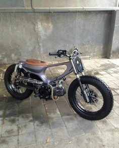 a motorcycle parked next to a building on a sidewalk