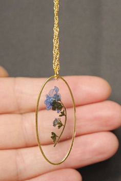 Blue Forget Me Not Flower Necklace , Real Pressed Flower in resin Jewelry , Gold necklace , Christmas Gifts for Mothers #NewJewelleryStory  #jewelry #necklace #flower Blue The Forget Me Not flower represents fidelity and never-ending love.The forget-me-not flowers are used to decorate gifts with the hope the recipient will not forget the giver. It also symbolizes faithful love and memories. Blue Flower Shaped Necklace Gift, Blue Flower Charm Necklace As Gift, Blue Flower Necklace For Gifts, Blue Flower Resin Jewelry, Blue Flower Jewelry For Mother's Day, Blue Jewelry With Pressed Flowers For Mother's Day, Mother's Day Blue Flower Jewelry, Resin Flower Jewelry With Flower Charm, Flower Shaped Resin Jewelry With Pressed Flowers