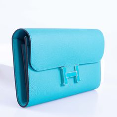 Despite its status as an extraordinary symbol of luxury, the allure of the Constance Long Wallet extends beyond its exclusivity. Resplendent in Blue Paon Epsom leather, this wallet exudes a rich hue that elevates it above traditional colors. Hermès, revered for its tradition of excellence, crafts this piece with meticulous attention to detail, featuring the iconic "H" clasp in striking gold. Palladium-tone hardware complements the clasp, adding a sleek appeal. The intelligently designed interior Hermes Constance, Mirror Interior, Sophisticated Design, Long Wallet, Gold Hardware, Slots, Wallet, Gold, Blue