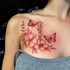 a woman with a butterfly and flower tattoo on her chest