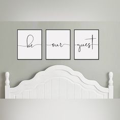 three posters on the wall above a bed in a room with gray walls and white furniture