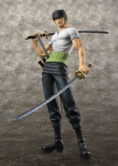 a figurine holding two swords in his right hand and wearing black pants with white shirt