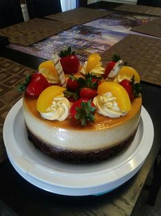 a cake with fruit on top sitting on a plate