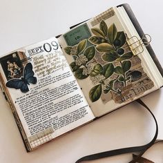 an open book sitting on top of a table next to scissors and a pair of scissors