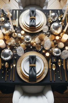 the table is set with black and gold place settings