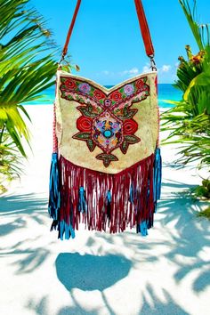 Santiago...Great Bohemian Bag, very special unique item white turquoise stone! Beautiful embroidered Boho bag with fringes! Front and back of skin with silver-colored streaks Trimmed with dark red suede fringes and shiny blue tassels Handle is dark red with gold-colored embroidery, [beautiful wide handle! Inside pocket with zipper & small pocket in the bag Lined with sturdy fabric on the inside Can be used as a crossbody bag / shoulder bag Bag with the absolute WOW factor Sizes: Width 30 cm Bag Bohemian Bags With Beaded Fringe For Everyday Use, Bohemian Beaded Tote Shoulder Bag, Bohemian Beaded Bags For Vacation, Bohemian Fringe Rectangular Hobo Bag, Bohemian Festival Bags With Beaded Fringe, Bohemian Brown Bag With Beaded Fringe, Bohemian Fringe Shoulder Bag For Vacation, White Beaded Bohemian Shoulder Bag, Bohemian Hobo Bag With Fringe For Travel