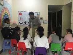 a man standing in front of a group of children