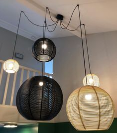 three lamps hanging from the ceiling in a room