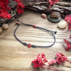 As soft and sweet as a single red rose on Valentine's Day to an edgy red and black reminder of the thorns that occupy something so beautiful, wear a tiny symbol of nature on your wrist! Find the matching "Valentine" classic version here: https://colorsoftheprairie.etsy.com/listing/1646047422  This listing is for 1 adjustable seed bead bracelet on black cord with red, green, and rose gold beads.  Each bracelet comes with a Colors of the Prairie logo charm/tag. - - - - - - - - - - - - - - -  ❂ 𝗦𝗜𝗭𝗘 ❂ Each bracelet adjusts between 5.5 - 10.5 inches (a standard size for this style). If you'd like the string ends to be shorter, they can be re-knotted and burned at the ends. If you have questions - please reach out. Once altered, I won't be able to accept them as returns. With a sliding knot Flower Beaded Bracelet, Single Red Rose, Rose Gold Beads, Dainty Bracelet, Sliding Knot, Flower Beads, Dainty Bracelets, String Bracelet, Seed Bead Bracelets