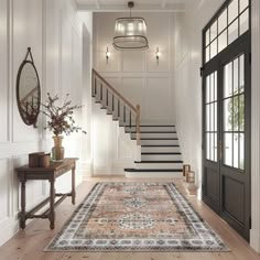 an entryway with stairs and rug in the middle