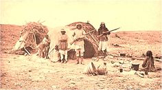 an old photo of some people in the desert