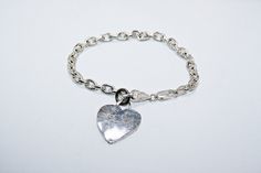 Sterling silver charm bracelet. Good condition, some minor wear commensurate to age. Patina untouched. See photos for measurements. Hallmarked on clasp. Charm is blank and ready to be engraved. Sterling Silver Charm Bracelet, Plastic Jewelry, Silver Charm Bracelet, Antique Metal, Sterling Silver Heart, Tiffany Heart, Heart Charm Bracelet, Sterling Silver Charm, Chain Link Bracelet