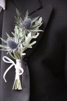 a boutonniere with thistles tied to it's lapel pin