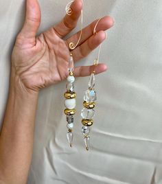 a person holding some kind of earrings in their hand