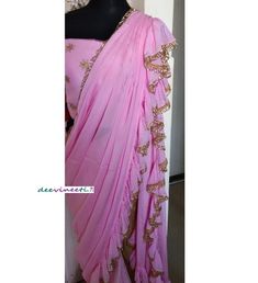 Color : PinkFabric - ChinonThis Ruffled Saree has beautiful Crystal Scallop trim at the hemline. Length of Saree 48 inches.Blouse : Pink Emroidered Net with Silk LiningThe blouse and underskirt/petticoat will be stitched as per the measurements providedIF YOU WISH TO PURCHASE THIS WE CAN SEND A VIDEO ON YOUR WHATSAPP NUMBER FOR BETTER UNDERSTANDING OF THE SAREEFabric Care : Dry Clean OnlyDisclaimer: The actual color of the product might slightly differ from the image due to photographic lighting Ruffled Saree, Bridesmaid Saree, Ruffle Saree, Scallop Trim, Whatsapp Number, Wedding Bridesmaid, Indian Designer, Indian Design, Photographic Lighting