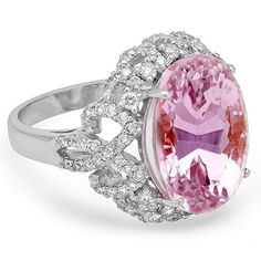 an oval shaped pink and white stone ring with diamond accents on the band, set in 18k white gold