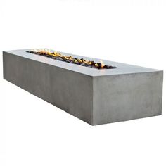 a concrete fire pit with flames on top