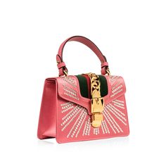 The Gucci Sylvie is one of those bags that became a classic the moment it landed in stores – and though we love a traditional classic here at rmia bags, we love a classic with a modern twist even more. Crafted from pink satin, featuring the brand’s signature green and red fabric strip, prominent gold-tone buckle detail and embellished with crystals throughout, it’s safe to say that this bag is basically the greatest thing you’ve ever seen. This Sylvie is luxurious, glamorous, completely OTT and the perfect accessory to compliment to any neutral-toned or monochromatic outfit. Whether you dress the Sylvie up or down, you can be sure this bright, bold piece is the ideal accessory for any occasion. Joyous, youthful and effortlessly elegant at the same time, the Sylvie is a well-worthy addition Gucci Sylvie, Gucci Mini, Monochromatic Outfit, Gucci Models, S Signature, Green And Red, Gucci Handbags, Red Fabric, Satchel Bag