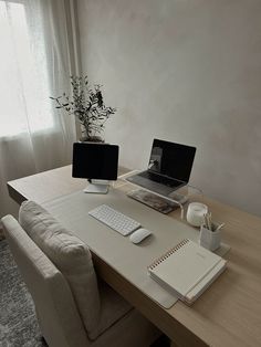 a laptop computer sitting on top of a wooden desk next to a keyboard and mouse