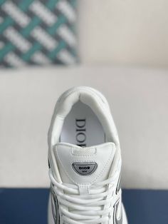 Embrace a sleek and sporty aesthetic with these Dior B30-inspired sneakers in a pristine white colorway. Crafted with breathable mesh and technical fabric, these shoes are perfect for those who value style and performance. The lightweight construction and sculpted rubber sole ensure all-day comfort and support, while the signature "CD30" logo adds a touch of Dior's iconic style. Whether you're hitting the gym or the streets, these sneakers will elevate your look with a touch of understated luxur White Sneakers For Sports, White Mesh Running Shoes With Abzorb Midsole, White Breathable Sneakers, Medium Fit, White Breathable Sneakers Medium Fit, White Mesh Running Shoes With Medium Fit, White Mesh Running Shoes Medium Fit, Luxury Low-top Sneakers With Air Cushioning, White Mesh Running Shoes, Modern White Sneakers With Ventilation