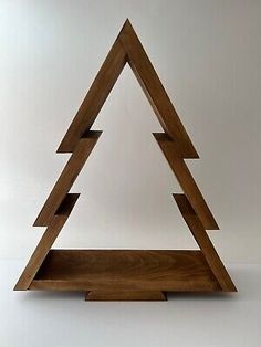 a wooden shelf with three triangular shaped shelves